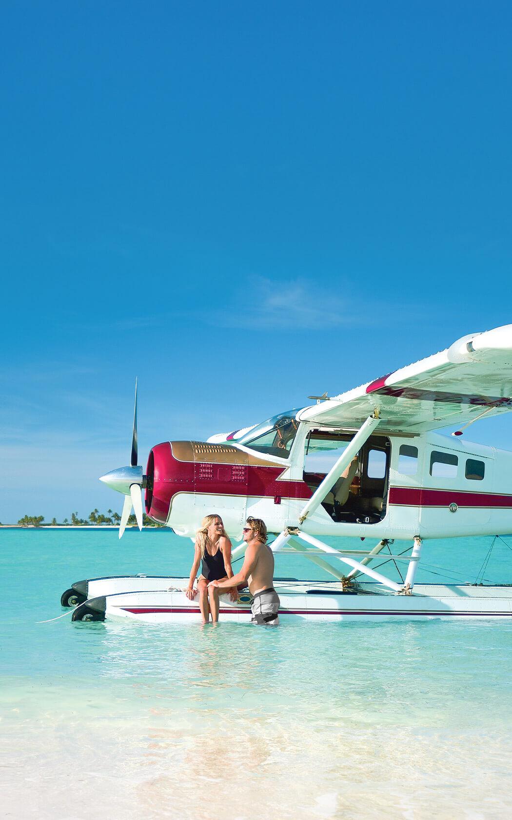 couple sitting on a seaplane's float