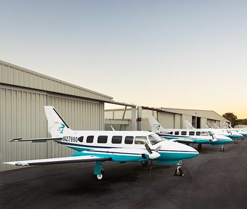 front view of propeller airplane on tarmack